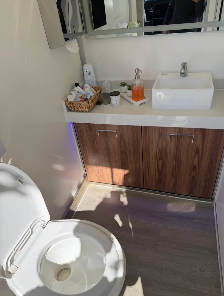 Wood vanity inside a restroom trailer